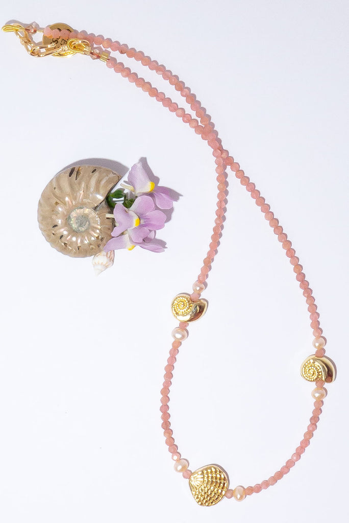 This delicate strand of peachy pink gemstones & golden glowing shells is the perfect necklace to wear on its own or as a beautiful pop of colour in your next necklace stack.