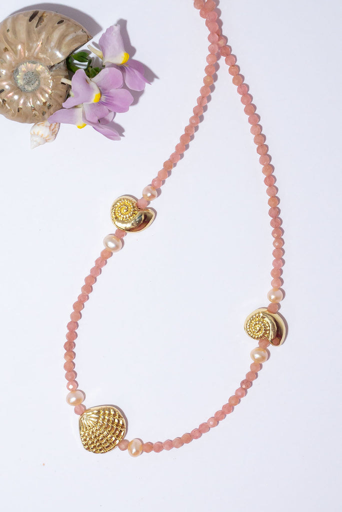 This delicate strand of peachy pink gemstones & golden glowing shells is the perfect necklace to wear on its own or as a beautiful pop of colour in your next necklace stack.