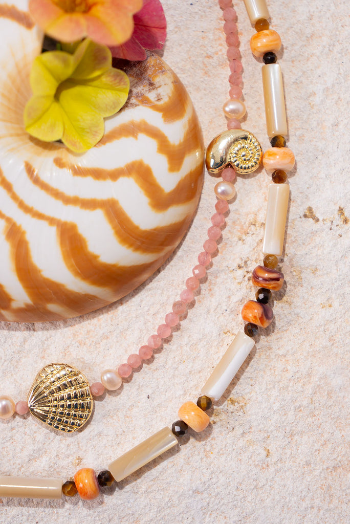 This gorgeous necklace features warm spice tones and shimmering creamy mother of pearl.