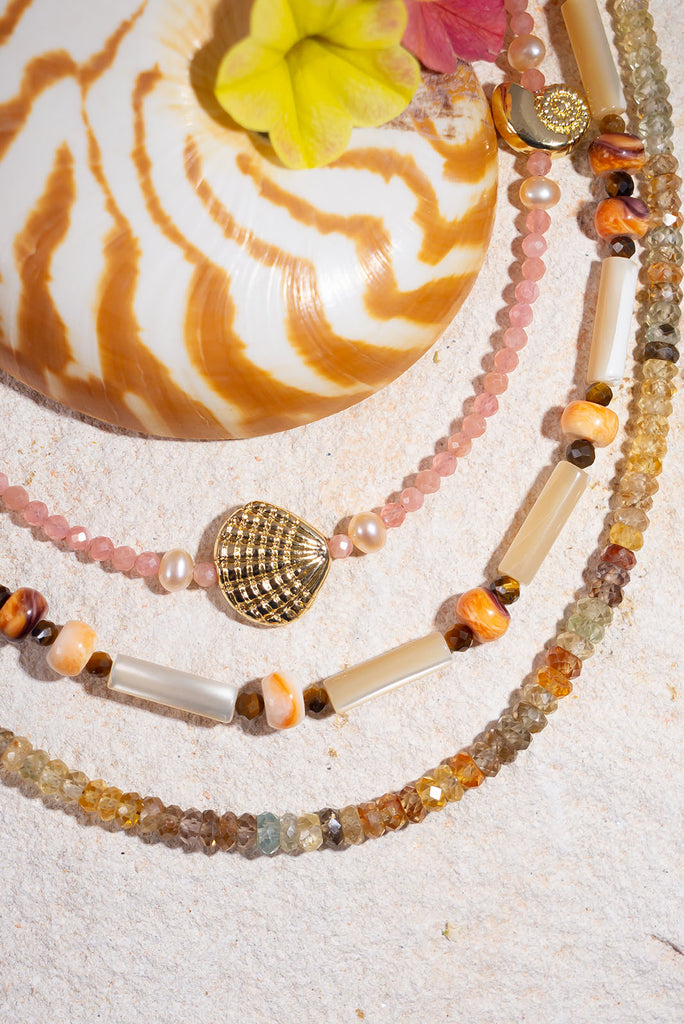 This gorgeous necklace features warm spice tones and shimmering creamy mother of pearl.