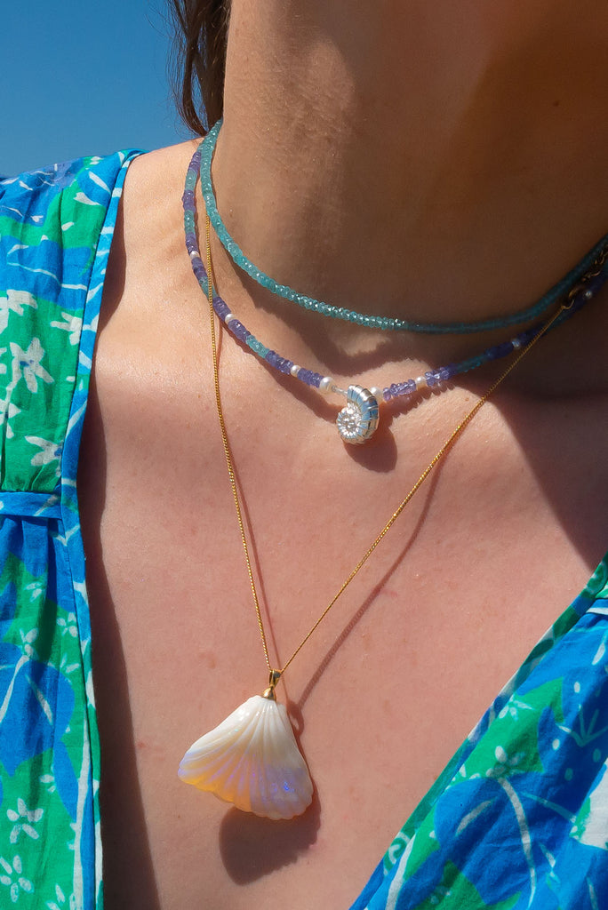 For lovers of the ocean this gorgeous necklace is calling to you. Featuring sparkling gemstones and a solid silver shell pendant this is the perfect piece for days spent by the sea.