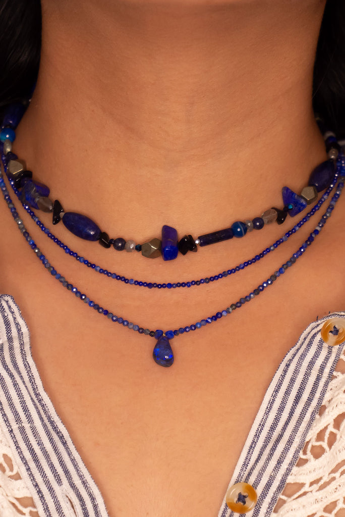 A bright splash of blue, a solid black opal with the intensity of bright cobalt blue deep in the stone, on a deep blue Lapis Lazuli tiny faceted bead necklace.
