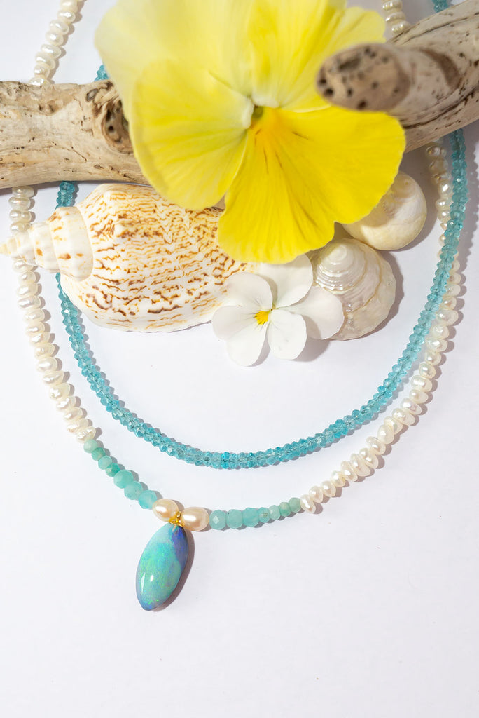 Tiny lustrous Baroque pearls with a pale blue pond of Amazonite beads, the centrepiece is a gorgeous swirl of sea blue Australian opal, a pearl necklace that has the calm and colours of a South Pacific island.