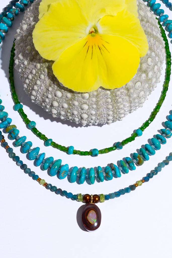 Like the desert coming to life during the rainy season this enchanting necklace features beautiful earthy tones and the warm toned greens of Summer.