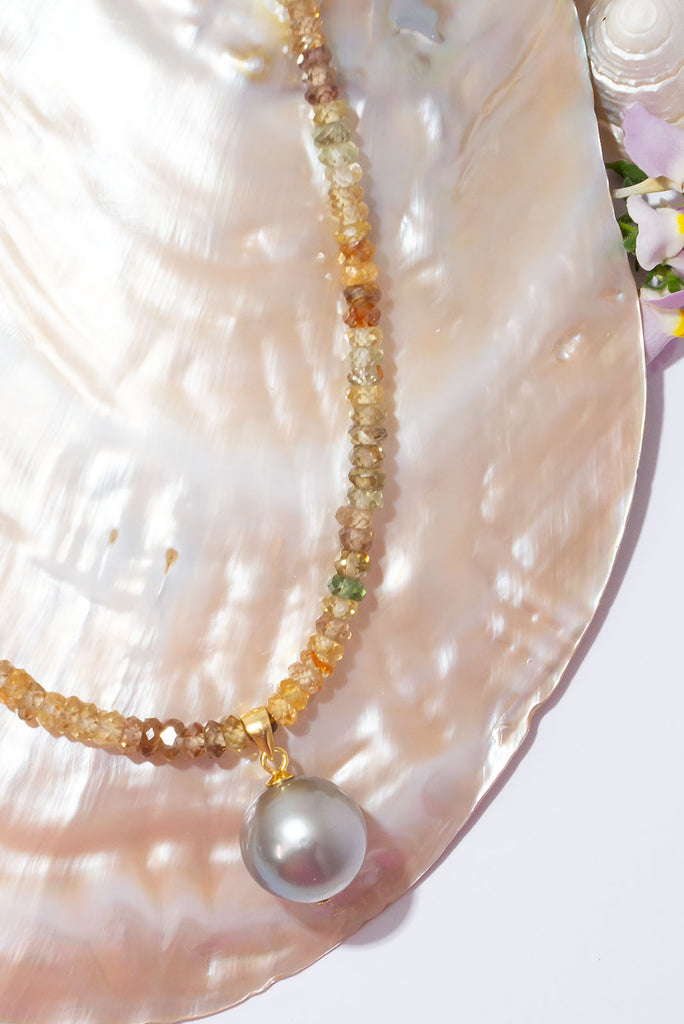 A gorgeous warm grey pearl sits amongst a sparkling strand of multi toned zircons. This piece truly shimmers in the sunlight.