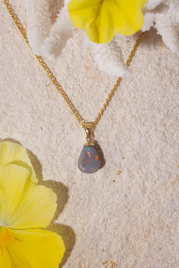 The little sister of our beautiful Pendant Australian Opal Soul Fire this gorgeous piece was cut from the same stone. With a strong flash of red and yellow across the front this stone dances with colour in the sunlight.