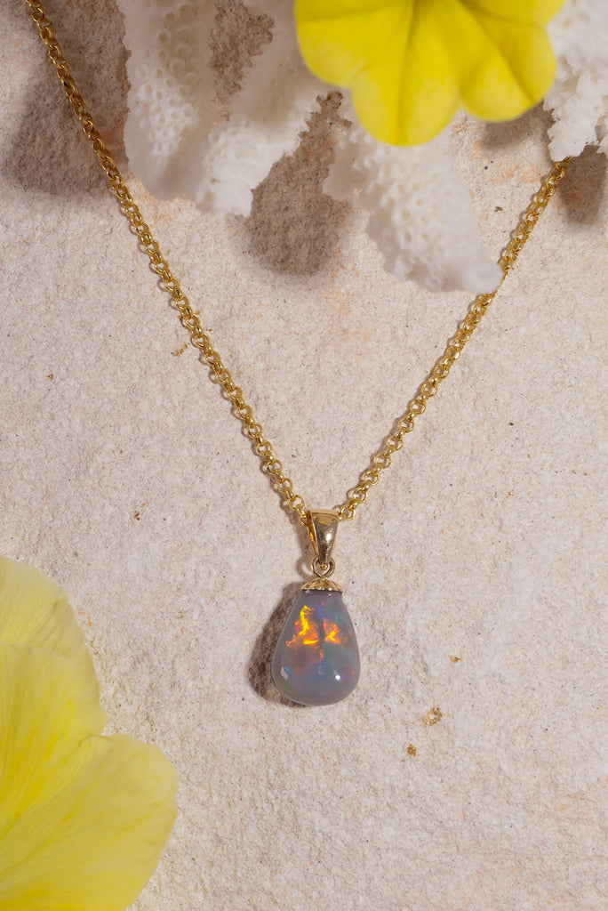 The little sister of our beautiful Pendant Australian Opal Soul Fire this gorgeous piece was cut from the same stone. With a strong flash of red and yellow across the front this stone dances with colour in the sunlight.