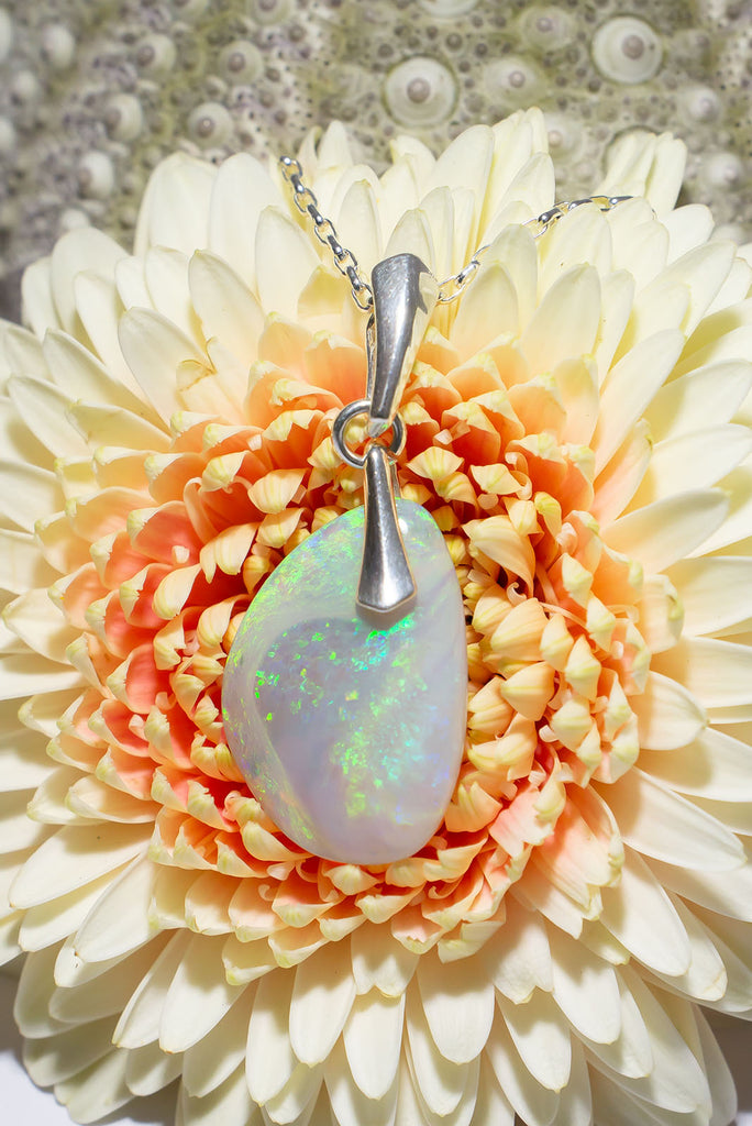 This gorgeous freeform solid Australia opal pendant features shimmer streams of green opal.