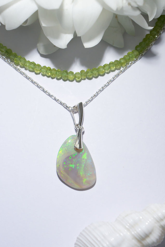 This gorgeous freeform solid Australia opal pendant features shimmer streams of green opal.