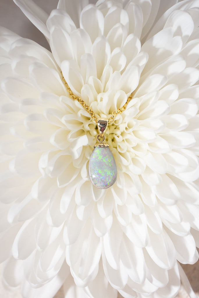 This gorgeous natural solid Australian Opal features two different types of opal within the one piece. The front face is a white grey opal with a beautiful blue/green sparkling colour play and the back is a grey jelly opal with a subtle blue/purple colour flash.