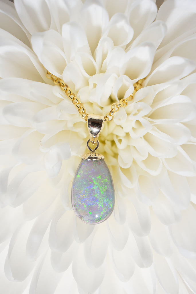 This gorgeous natural solid Australian Opal features two different types of opal within the one piece. The front face is a white grey opal with a beautiful blue/green sparkling colour play and the back is a grey jelly opal with a subtle blue/purple colour flash.