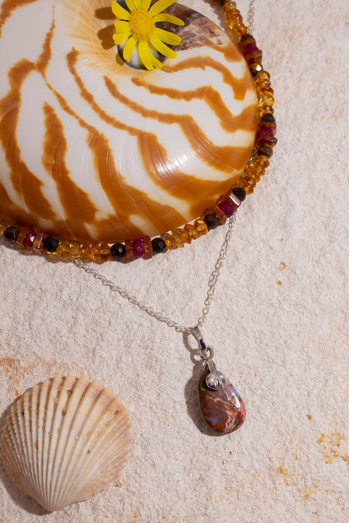 Discover the beauty of Australian Boulder Opal with this delicate pendant.