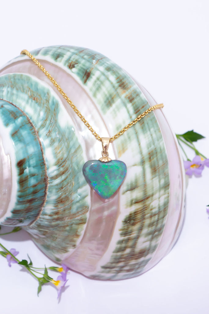 Discover this shimmering Australian Opal Heart pendant. Filled with glittering swirls of green and aqua fire.