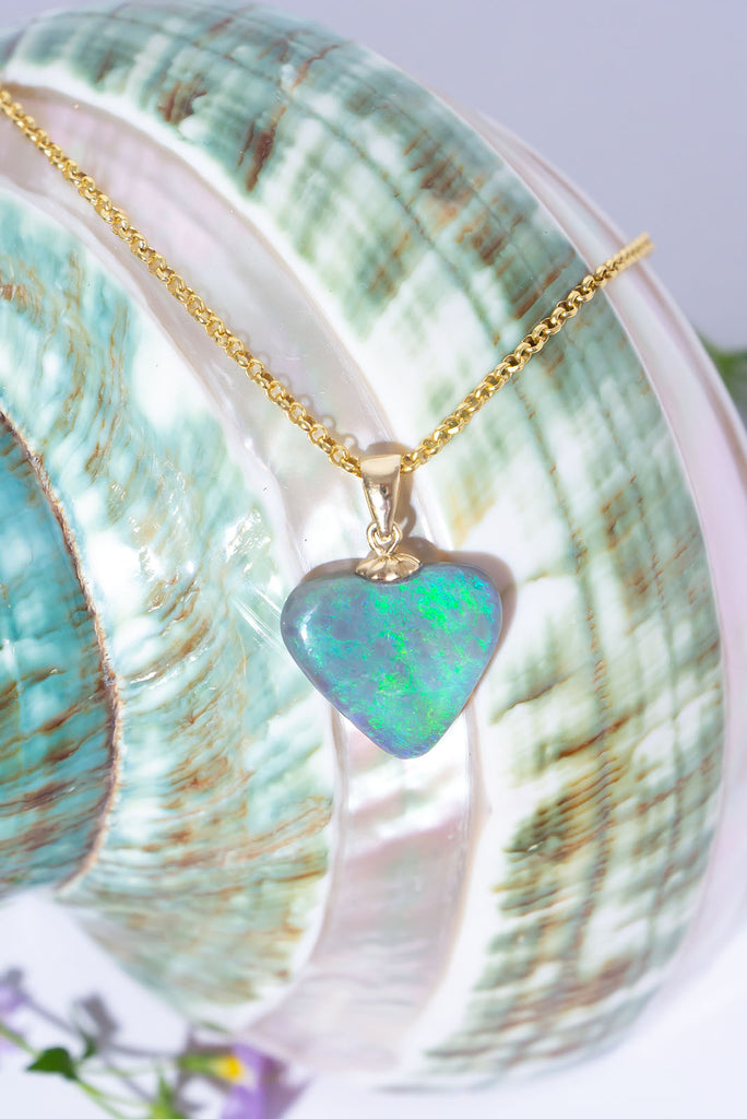 Discover this shimmering Australian Opal Heart pendant. Filled with glittering swirls of green and aqua fire.