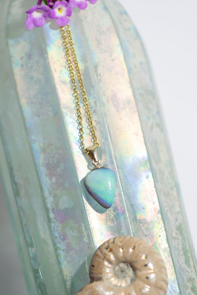 A tide of green, blue and mauve sprinkle swirls across the crystal sea on this Opal heart shaped pendant. Delicate and elegant.