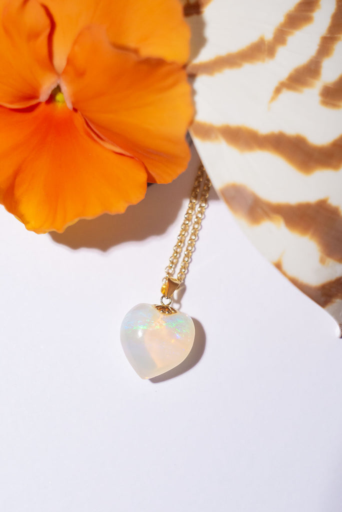 As soft as an ocean breeze this beautiful heart shaped opal pendant has peaceful drifts of green, blue and mauve floating above a pale gold sea.