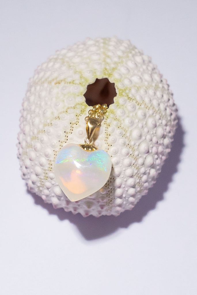 As soft as an ocean breeze this beautiful heart shaped opal pendant has peaceful drifts of green, blue and mauve floating above a pale gold sea.