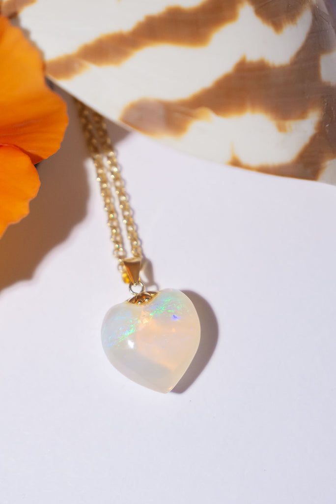 As soft as an ocean breeze this beautiful heart shaped opal pendant has peaceful drifts of green, blue and mauve floating above a pale gold sea.