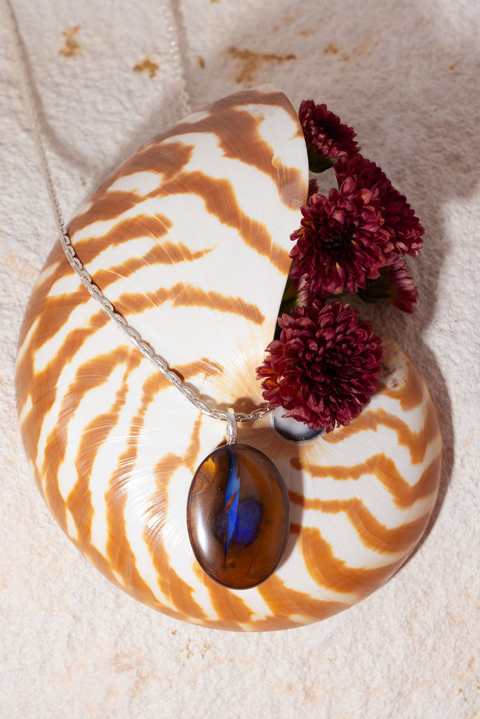 Like a flash of lightning across a desert landscape this unique Australian boulder opal pendant features a gorgeous bolt of deep indigo crystal with flashes of blue fire.