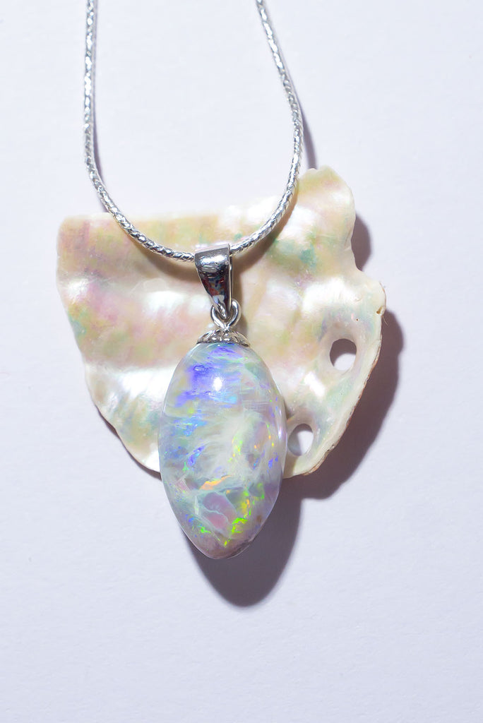 The enthralling colour play in this stunning solid Australian opal pendant is truly exceptional. Within this stone you will find a beautiful bright rolling green flash that needs no extra light to shine and a gorgeous overlay of glowing blue fire crystal opal.