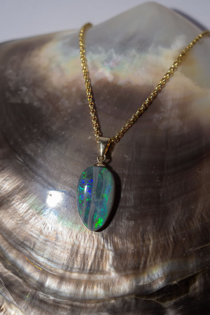 This unusual semi black opal has really interesting detail, it resembles an ancient road travelling across the landscape of green and blue.