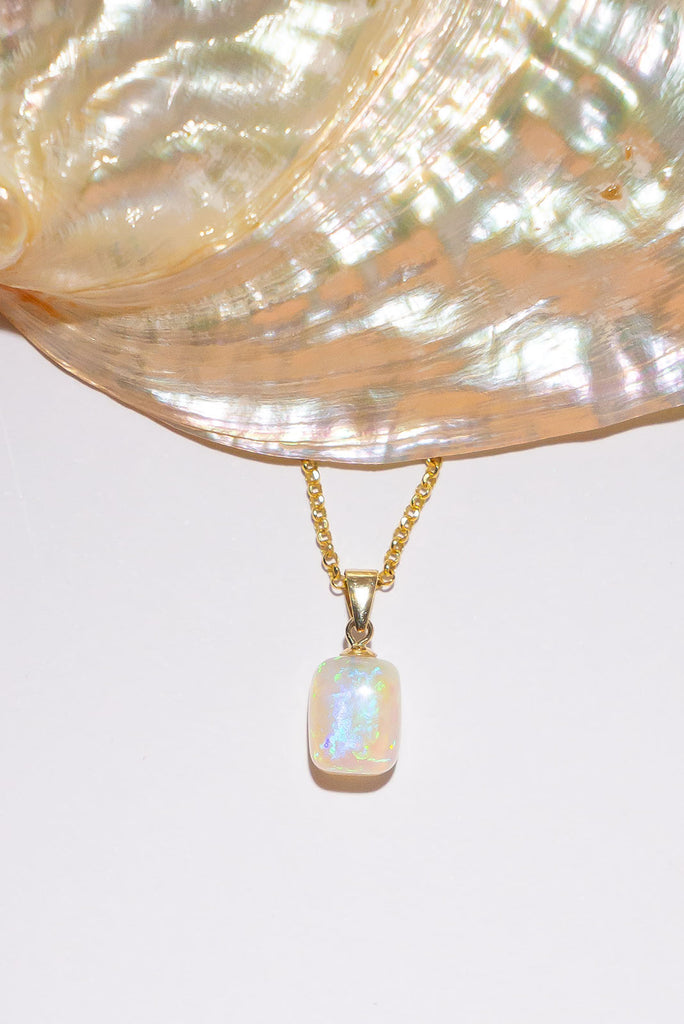 Bright blue flash and green sparkle, this crystal opal is a precious drop of ancient water silkily flowing through the stone.