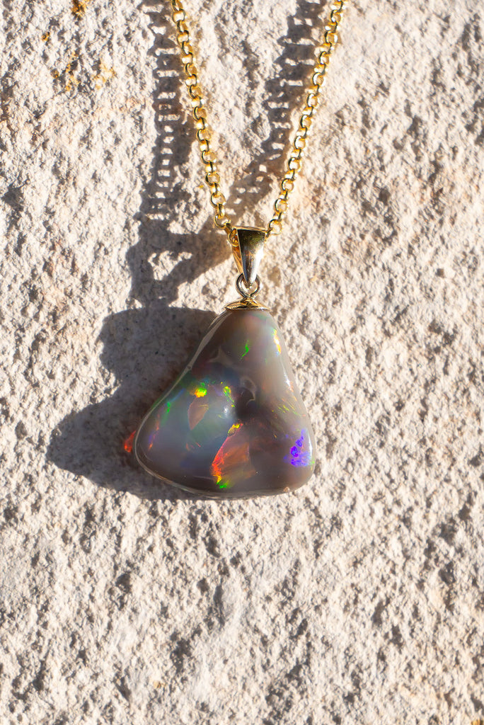 With a different rainbow of colour from every direction this exceptional opal pendant follows the natural undulations of the original stone rough to create the most intense pattern of rainbow colour play.