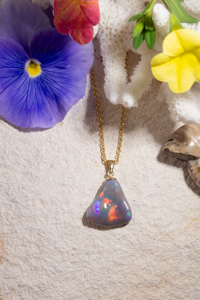 With a different rainbow of colour from every direction this exceptional opal pendant follows the natural undulations of the original stone rough to create the most intense pattern of rainbow colour play.