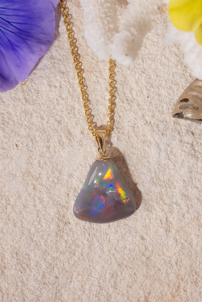 With a different rainbow of colour from every direction this exceptional opal pendant follows the natural undulations of the original stone rough to create the most intense pattern of rainbow colour play.