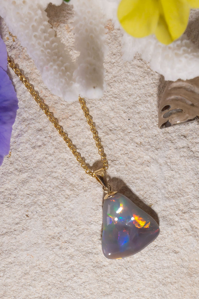 With a different rainbow of colour from every direction this exceptional opal pendant follows the natural undulations of the original stone rough to create the most intense pattern of rainbow colour play.