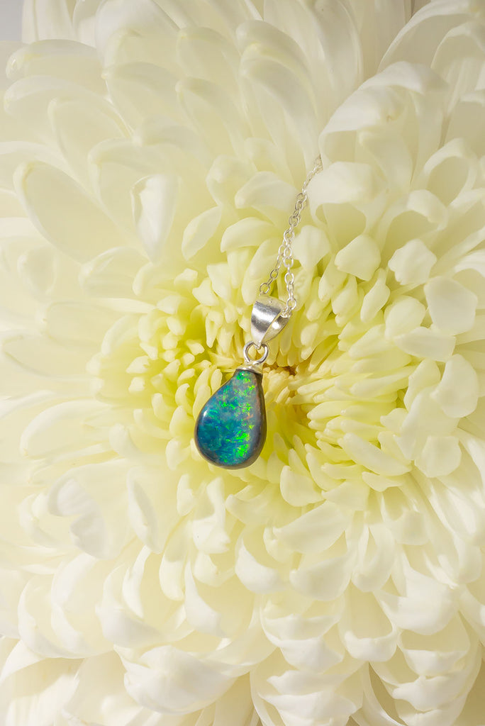 A tiny splash of cool crystal water, a splash of summer rain on green grass, this little opal pendant with its blues and greens is perfect.