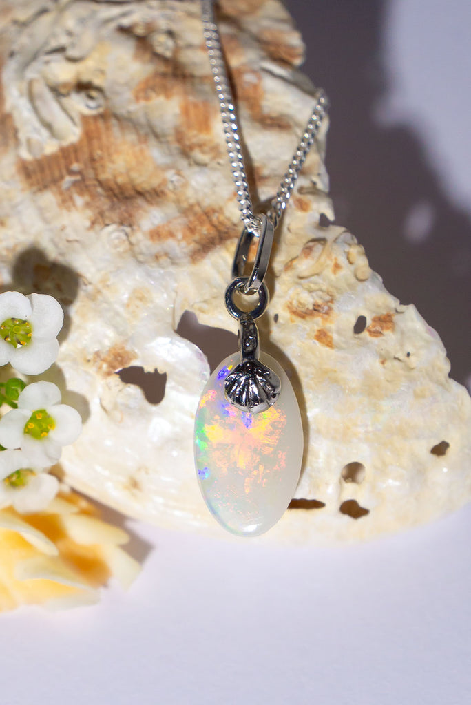 A tiny bright flash of sunset rays, this unique little drop of opal perfection has flashes of bright red, gold and blue across the stone. Absolute perfection in an opal pendant.