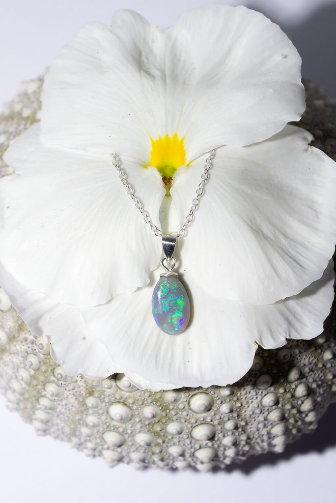 A tiny splash of the island waters, this black opal pendant has a tinsel splash of green and blue it looks even more perfect in sunlight.