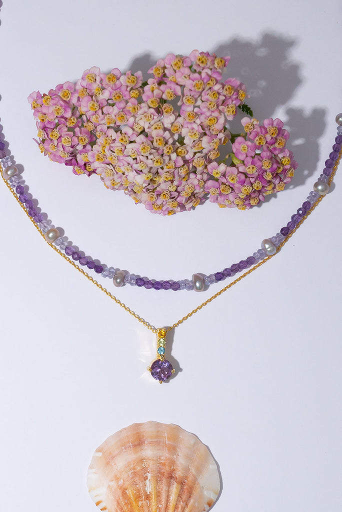 Inspired by the lavender and heather fields this pretty sparkling pendant features a round faceted Amethyst gemstone set in 9ct gold vermeil, the accent is a bar of tiny faceted gemstones. Made exclusively for Mombasa Rose Boutique.