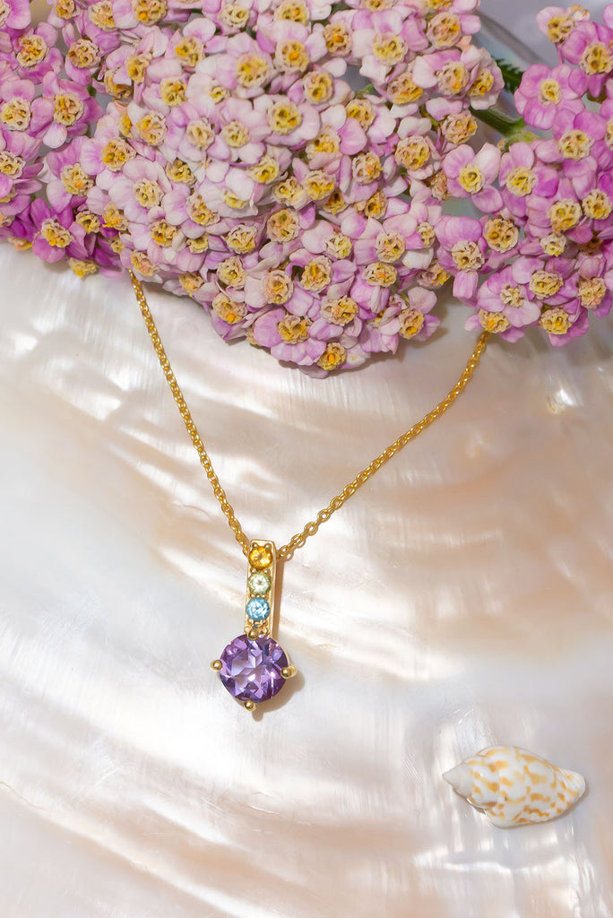 Inspired by the lavender and heather fields this pretty sparkling pendant features a round faceted Amethyst gemstone set in 9ct gold vermeil, the accent is a bar of tiny faceted gemstones. Made exclusively for Mombasa Rose Boutique.