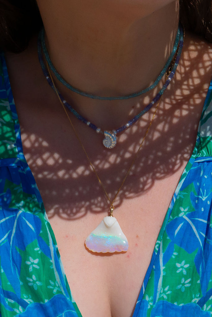 An absolute stunner, this mystical crystal opal skilfully carved into the shape of a whale tail, a dreamy and tactile opal pendant that is a one off piece.