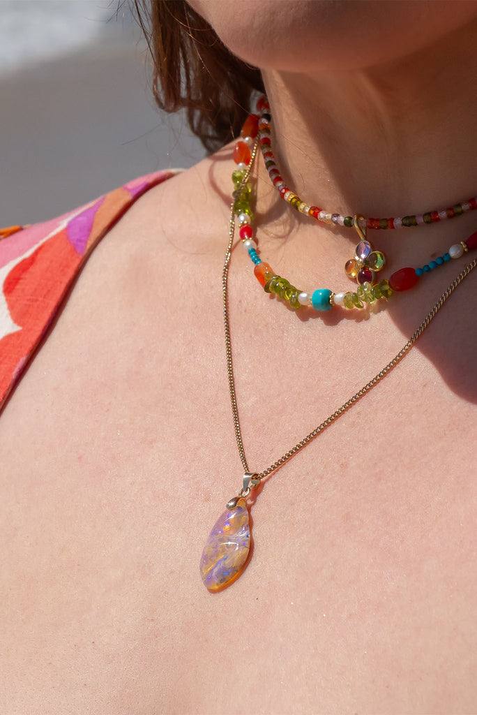 An absolutely stunning opal pendant featuring a soft droplet of Australian crystal opal cut and polished to reveal the wonderful colour and sand that reveals itself underneath.