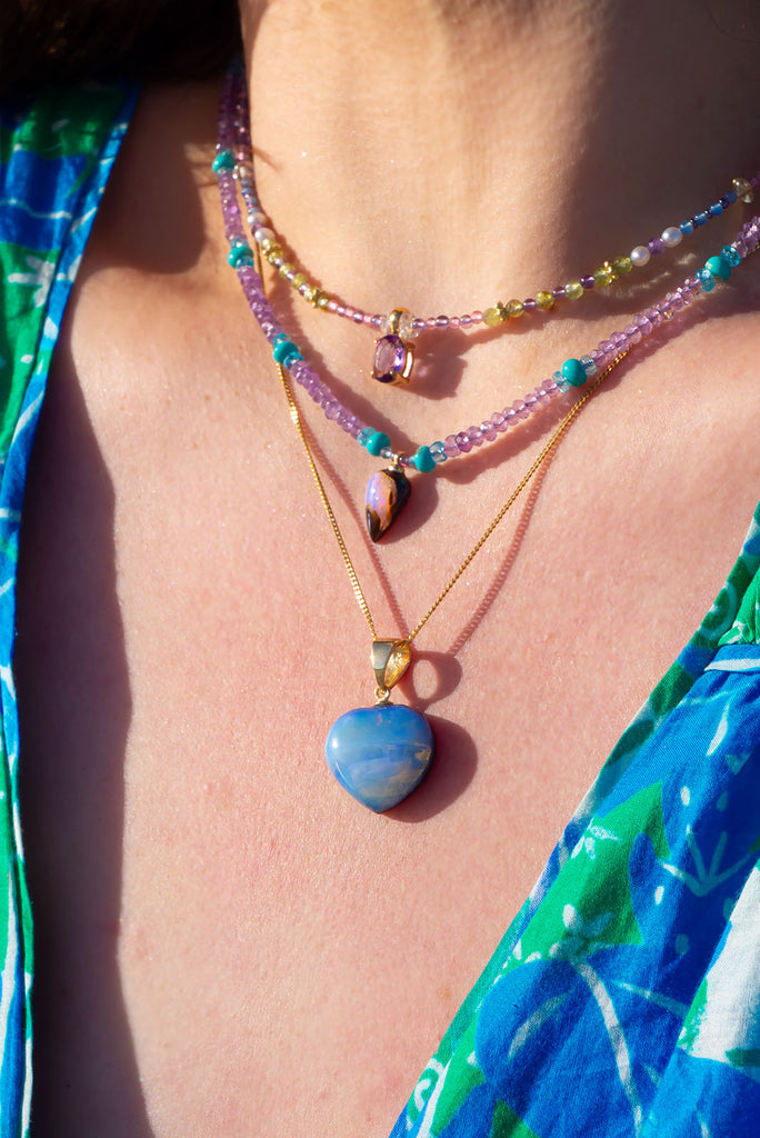 A lovely dreamy stone, an opal heart as pretty as the clouds across the sky.