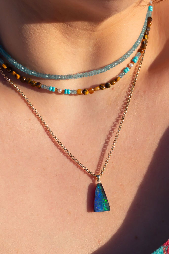 As the deep ocean meets the island lagoon so the blues and greens in this opal pendant sparkle with the colours of a pacific.